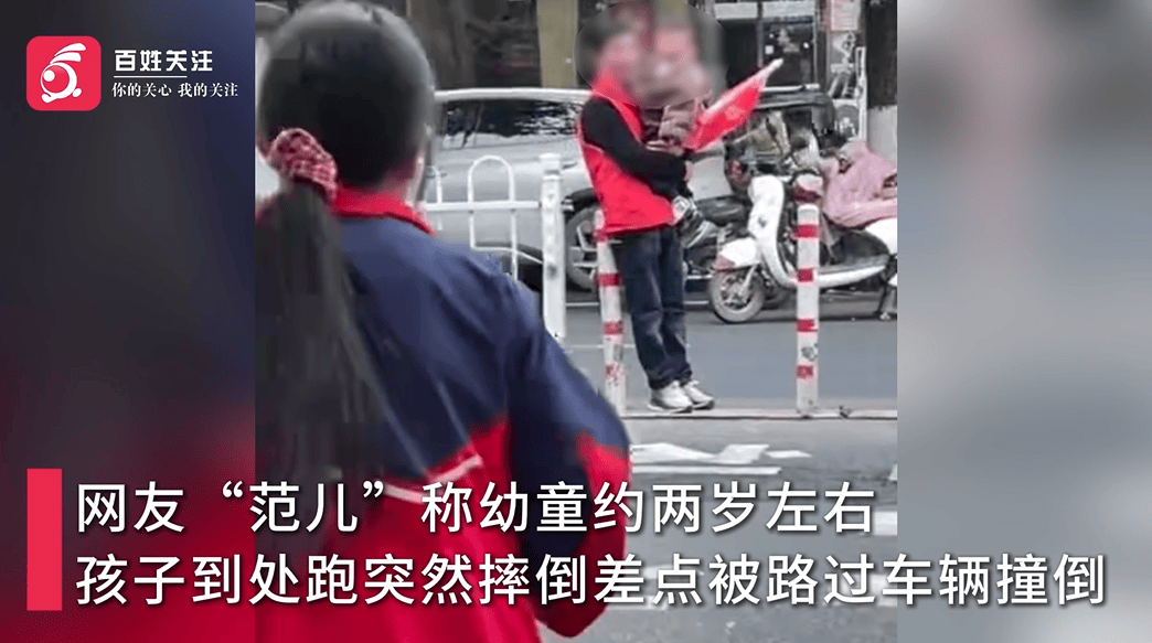皇冠信用网_老人抱幼童在马路中间参与“护学岗” 皇冠信用网，教育局回应